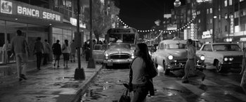 Movie still from “Roma” (2018), directed by Alfonso Cuarón – A black and white photo of a woman walking down the street; Wide shot, Low angle