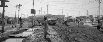 Movie still from “Roma” (2018), directed by Alfonso Cuarón – An old photo of a woman in a dirt field; Wide shot, High angle