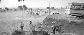 Movie still from “Roma” (2018), directed by Alfonso Cuarón – A black - and - white photo of a group of people; Extreme Wide shot, High angle