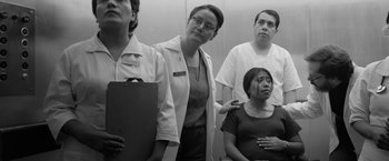 Movie still from “Roma” (2018), directed by Alfonso Cuarón – A black and white photo of a group of doctors; Medium shot, Over the shoulder angle