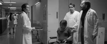 Movie still from “Roma” (2018), directed by Alfonso Cuarón – A man standing next to a woman sitting in a wheelchair; Medium shot, Over the shoulder angle