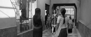 Movie still from “Roma” (2018), directed by Alfonso Cuarón – A group of people standing in a room; Medium shot, Over the shoulder angle