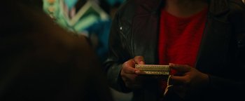 Movie still from “Roxanne Roxanne” (2017), directed by Michael Larnell – A person holding a box in their hands; Extreme Close Up shot, Over the shoulder angle