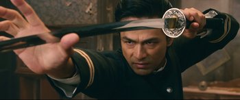 Movie still from “Rurouni Kenshin Part I: Origins” (2012), directed by Keishi Otomo – A person holding a sword; Close Up shot, Over the shoulder angle