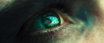 Movie still from “Rush” (2013), directed by Ron Howard – A person's eye with a green light coming out of it; Extreme Close Up shot, High angle