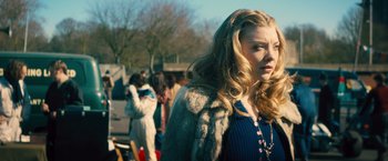 Movie still from “Rush” (2013), directed by Ron Howard – A woman with long blonde hair wearing a fur coat; Close Up shot, Over the shoulder angle