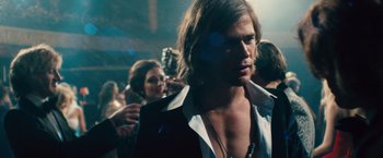 Movie still from “Rush” (2013), directed by Ron Howard – A person wearing a suit and tie; Close Up shot, Over the shoulder angle