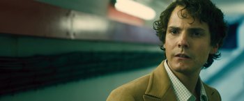 Movie still from “Rush” (2013), directed by Ron Howard – A person wearing a jacket; Close Up shot, Low angle