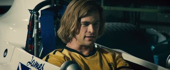 Movie still from “Rush” (2013), directed by Ron Howard – A person with long blonde hair; Close Up shot, Low angle