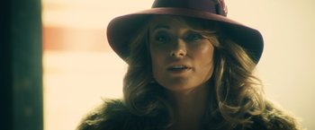 Movie still from “Rush” (2013), directed by Ron Howard – A person wearing a hat; Close Up shot, Over the shoulder angle