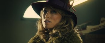 Movie still from “Rush” (2013), directed by Ron Howard – A person wearing a hat; Close Up shot, Over the shoulder angle