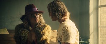 Movie still from “Rush” (2013), directed by Ron Howard – A man and a woman standing next to each other; Medium shot, Over the shoulder angle