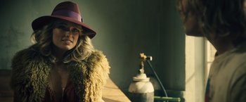 Movie still from “Rush” (2013), directed by Ron Howard – A woman wearing a fur coat and a red hat; Close Up shot, Low angle