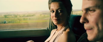 Movie still from “Rush” (2013), directed by Ron Howard – A woman sitting in a car looking out the window; Close Up shot, Over the shoulder angle