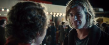 Movie still from “Rush” (2013), directed by Ron Howard – A man with long blonde hair is talking to another man; Close Up shot, Over the shoulder angle