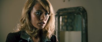 Movie still from “Rush” (2013), directed by Ron Howard – A person wearing a necklace; Close Up shot, Over the shoulder angle