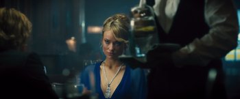 Movie still from “Rush” (2013), directed by Ron Howard – A beautiful blonde woman wearing a blue dress; Close Up shot, Over the shoulder angle