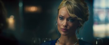 Movie still from “Rush” (2013), directed by Ron Howard – A beautiful blonde woman with blue eyes; Close Up shot, Over the shoulder angle