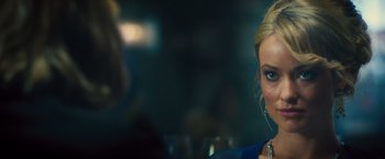 Movie still from “Rush” (2013), directed by Ron Howard – A woman is sitting in front of a glass of wine; Close Up shot, Over the shoulder angle