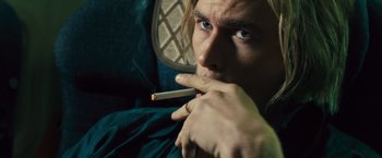 Movie still from “Rush” (2013), directed by Ron Howard – A person holding a cigarette in his mouth; Close Up shot, Over the shoulder angle