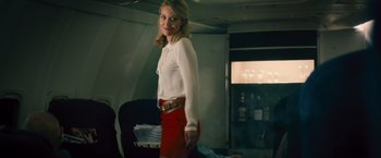 Movie still from “Rush” (2013), directed by Ron Howard – A woman in a white shirt and red skirt; Medium shot, Low angle