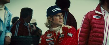 Movie still from “Rush” (2013), directed by Ron Howard – A person wearing a hat; Close Up shot, Low angle