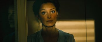 Movie still from “Rush” (2013), directed by Ron Howard – A person wearing a white shirt; Close Up shot, Over the shoulder angle