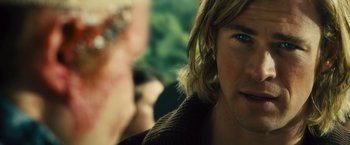Movie still from “Rush” (2013), directed by Ron Howard – A man with long blonde hair and blue eyes; Close Up shot, Over the shoulder angle