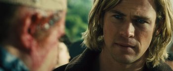 Movie still from “Rush” (2013), directed by Ron Howard – A person with long blonde hair; Close Up shot, Over the shoulder angle