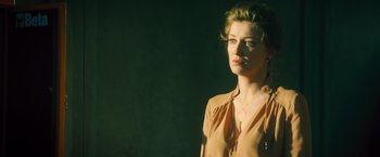 Movie still from “Rush” (2013), directed by Ron Howard – A woman in a brown shirt is looking at the camera; Close Up shot, Low angle