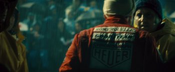 Movie still from “Rush” (2013), directed by Ron Howard – A person wearing a red jacket and a red helmet; Close Up shot, Low angle