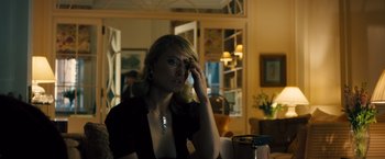 Movie still from “Rush” (2013), directed by Ron Howard – A woman sitting at a table in a room; Medium shot, Over the shoulder angle