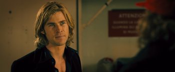 Movie still from “Rush” (2013), directed by Ron Howard – A person with long blonde hair; Close Up shot, Over the shoulder angle