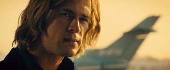 Movie still from “Rush” (2013), directed by Ron Howard – A person with long blonde hair; Close Up shot, Low angle