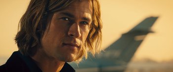 Movie still from “Rush” (2013), directed by Ron Howard – A person with long hair; Close Up shot, Low angle