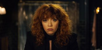 Movie still from “Russian Doll” (2019), created by Natasha Lyonne – A person with curly red hair; Close Up shot, Low angle