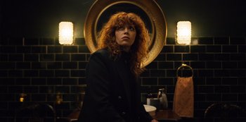 Movie still from “Russian Doll” (2019), created by Natasha Lyonne – A woman standing in front of a mirror in a bathroom; Medium shot, Low angle