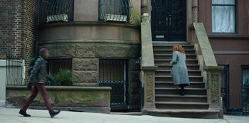 Movie still from “Russian Doll” (2019), created by Natasha Lyonne – A woman walking down the steps of a building; Wide shot, High angle