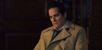 Movie still from “Russian Doll” (2019), created by Natasha Lyonne – A man in a trench coat and a tie; Close Up shot, High angle