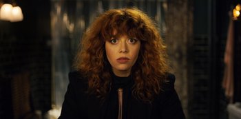 Movie still from “Russian Doll” (2019), created by Natasha Lyonne – A person with curly red hair; Close Up shot, Low angle