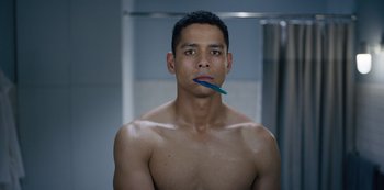 Movie still from “Russian Doll” (2019), created by Natasha Lyonne – A shirtless man with a toothbrush in his mouth; Close Up shot, Over the shoulder angle