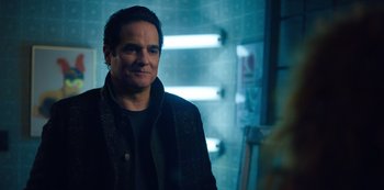 Movie still from “Russian Doll” (2019), created by Natasha Lyonne – A man standing in a room with lights in the background; Close Up shot, Over the shoulder angle