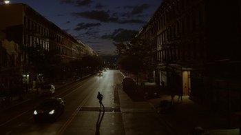 Movie still from “Mr. Robot” (2015), created by Sam Esmail – A person walking across a street at night; Extreme Wide shot, High angle