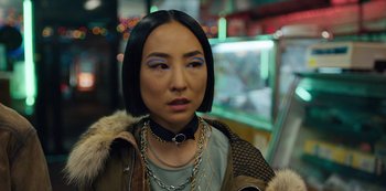 Movie still from “Russian Doll” (2019), created by Natasha Lyonne – A woman with a short black hair wearing a brown jacket; Close Up shot, Over the shoulder angle