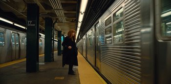 Movie still from “Russian Doll” (2019), created by Natasha Lyonne – A woman standing next to a train on a train platform; Wide shot, Low angle