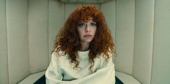 Movie still from “Russian Doll” (2019), created by Natasha Lyonne – A woman with red curly hair sitting in a chair; Close Up shot, High angle