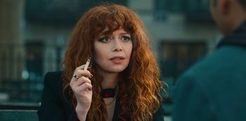 Movie still from “Russian Doll” (2019), created by Natasha Lyonne – A woman with long red hair talking on a cell phone; Close Up shot, Over the shoulder angle