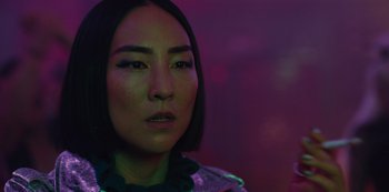 Movie still from “Russian Doll” (2019), created by Natasha Lyonne – A person wearing a dress with lights in the background; Close Up shot, Over the shoulder angle