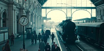 Movie still from “Russian Doll” (2019), created by Natasha Lyonne – A train station with people walking on the platform; Extreme Wide shot, High angle