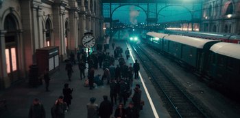 Movie still from “Russian Doll” (2019), created by Natasha Lyonne – People walking on a platform at a train station at night; Extreme Wide shot, High angle